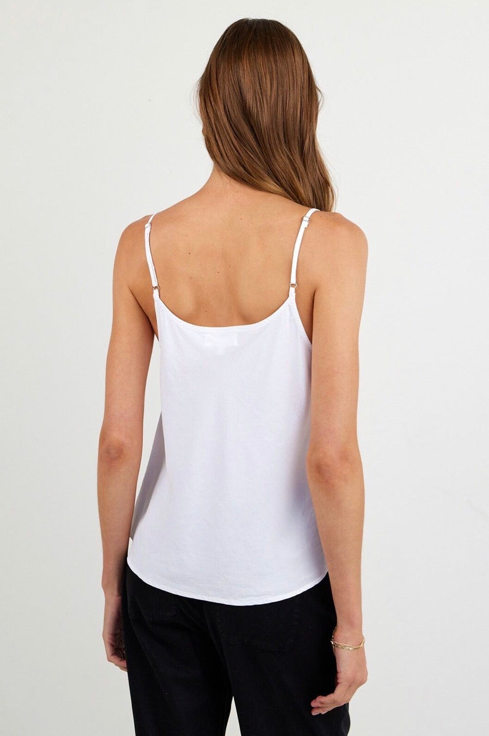Back view of woman wearing a white tanktop
