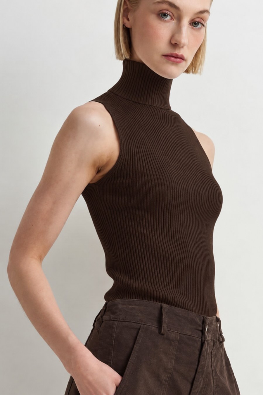 woman wearing sleeveless brown turtleneck sweater top 