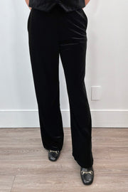 woman wearing black velvet pants