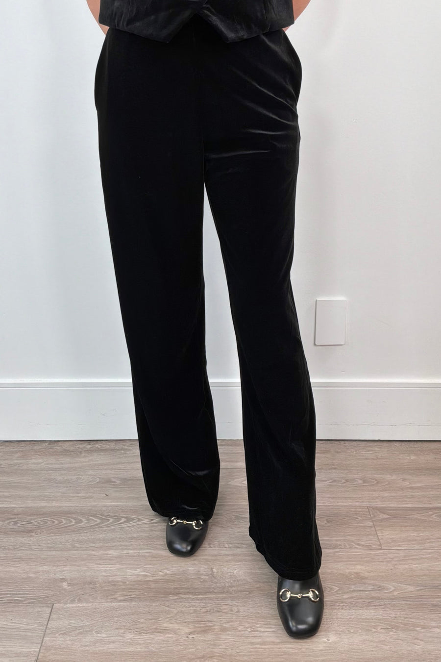 woman wearing black velvet pants