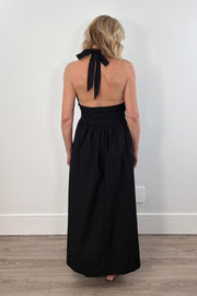 Woman wearing a black halter neck maxi dress