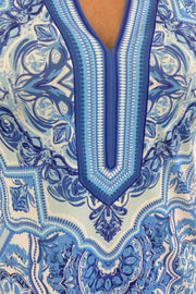 Close up of Woman wearing a blue patterned dress 