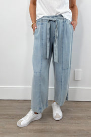 Woman wearing light blue chambray wide-leg pants with a drawstring waist, front view