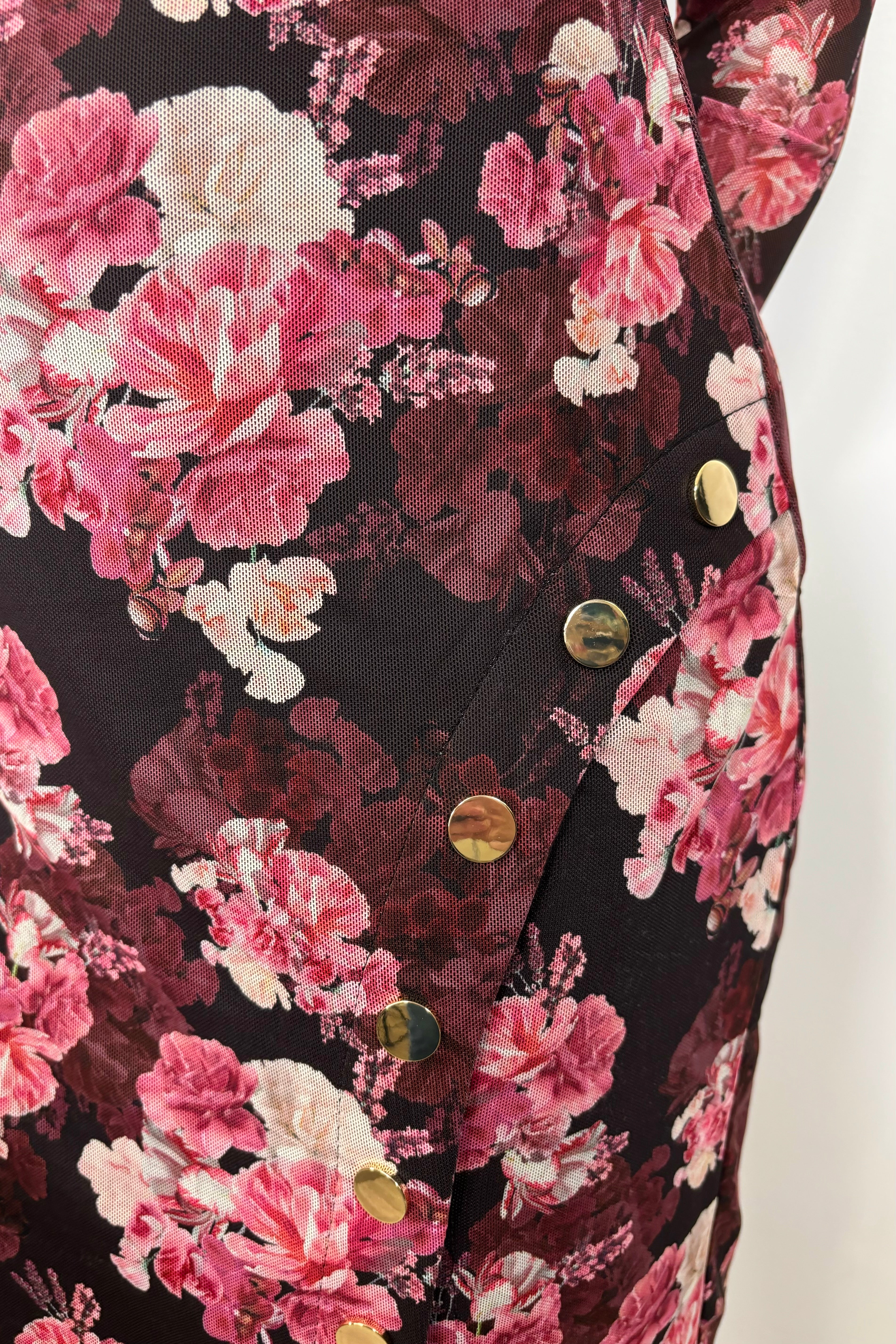 Close-up of the side of a floral mesh midi dress