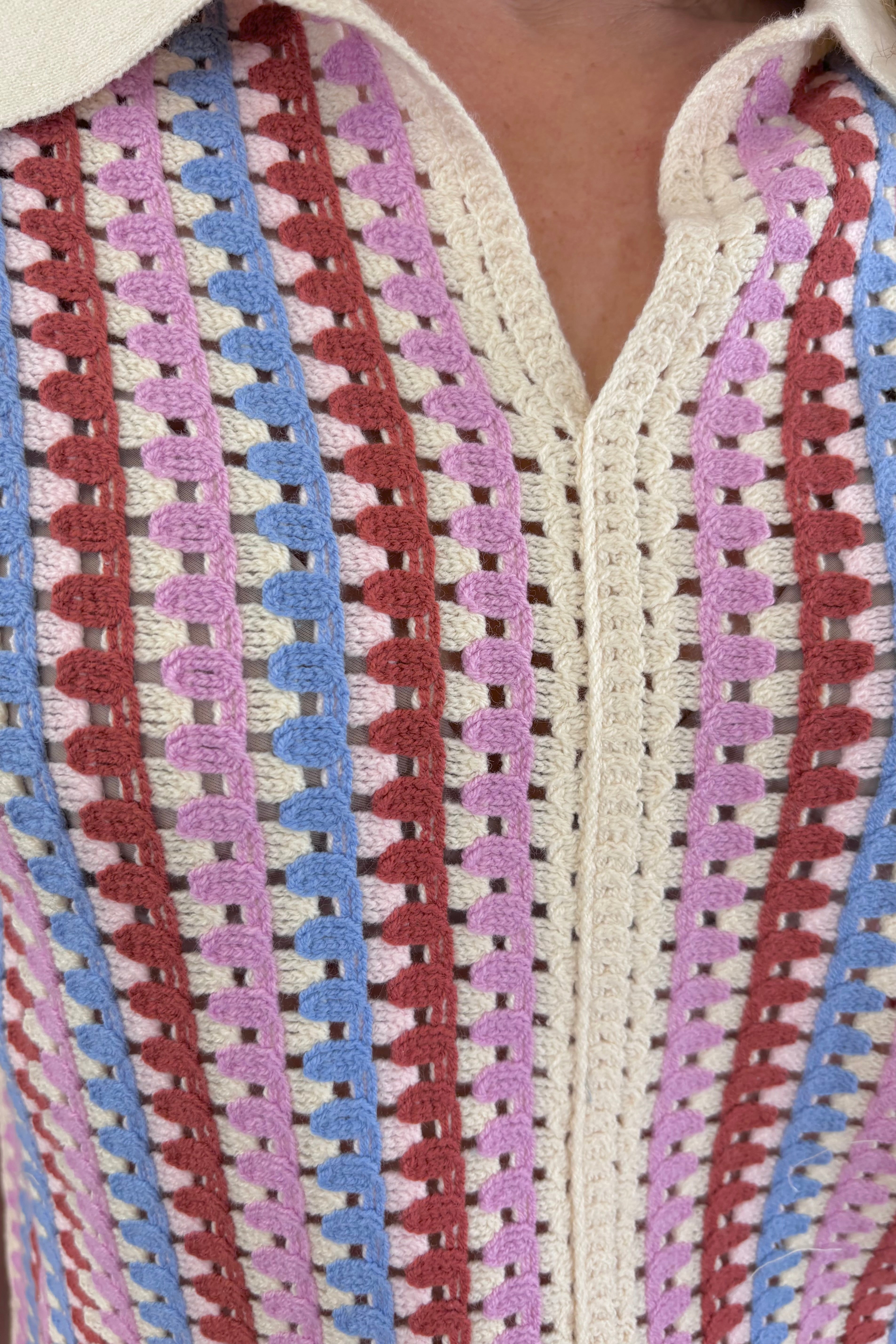 Close up of Woman wearing a warm colorful knit crochet polo 