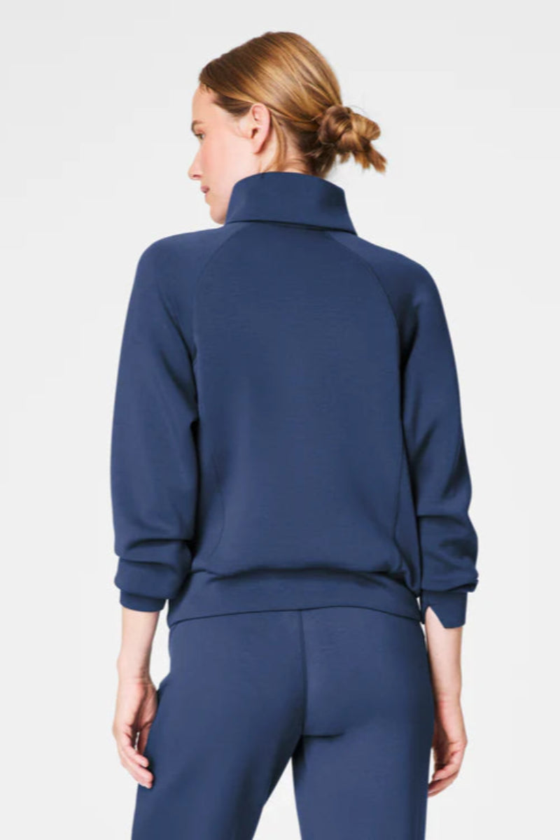 Person wearing a blue tracksuit on a white background