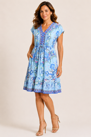 Women wearing blue floral patterned dress with scrunch tie around waist