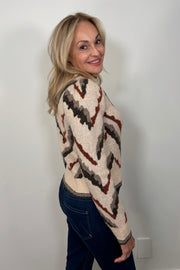 Side view of woman wearing a jacquard pattern sweater