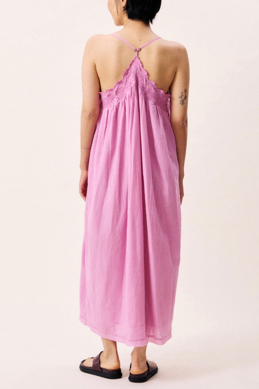 Back view of woman wearing a pink sundress