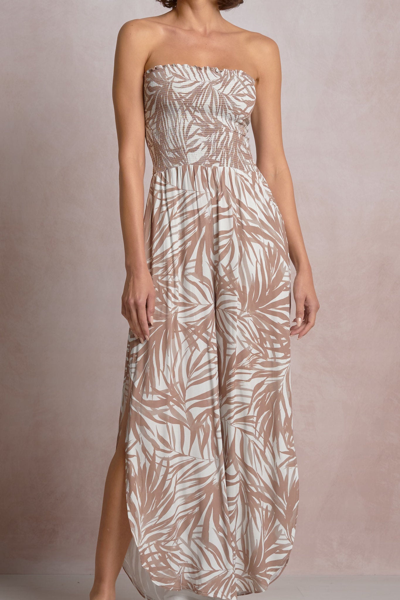 Close-up of a beige and white strapless dress with a  palm leaf pattern