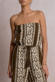 Woman wearing a strapless patterned jumpsuit 