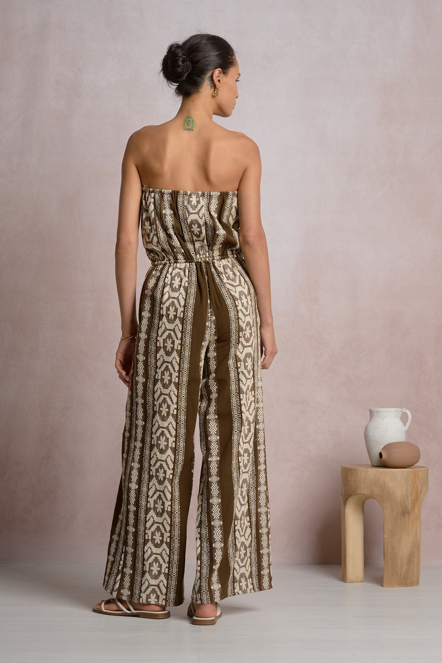 Woman wearing a strapless patterned jumpsuit 