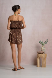 Woman in a brown strapless romper