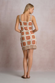 an orange, white and beige patterned crochet short dress 
