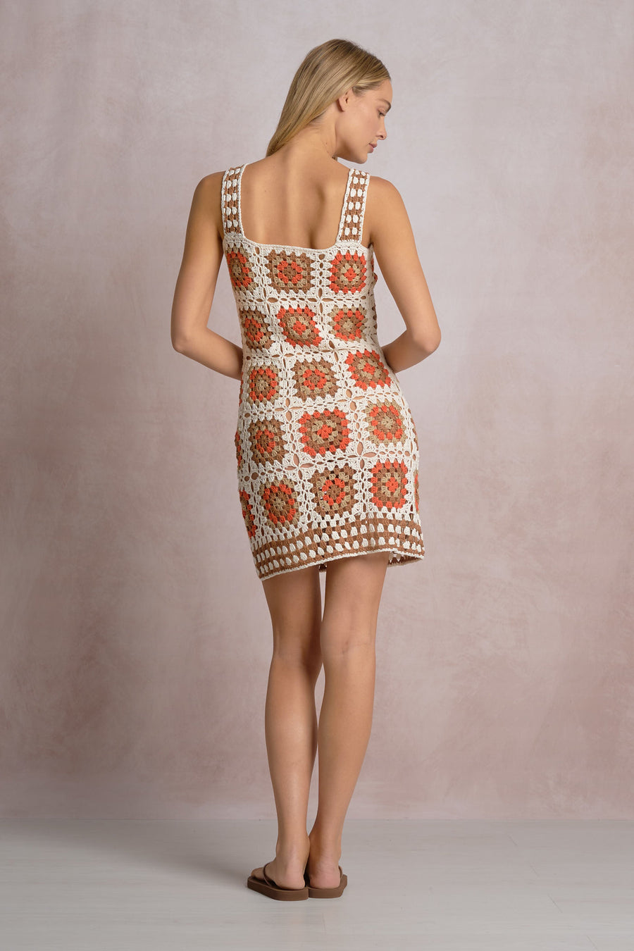 an orange, white and beige patterned crochet short dress 