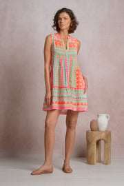 woman wearing a colorful printed sleeveless short dress 