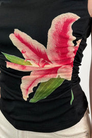 Closeup of Woman wearing a velvet top with flower graphic
