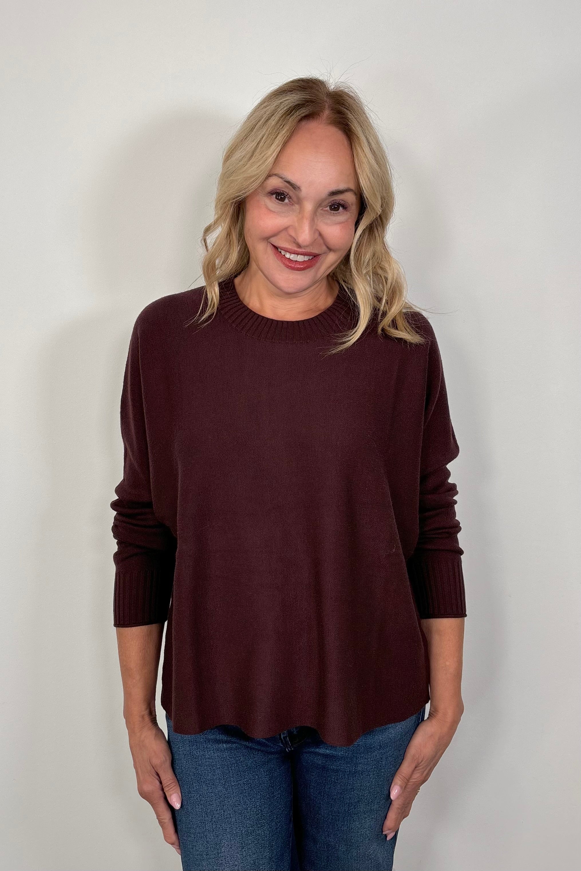 woman wearing a burgundy crewneck sweater