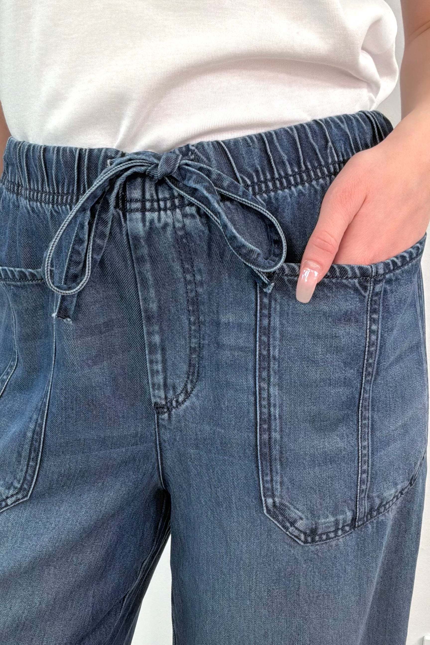 close-up of an ankle length blue tencel denim wide leg pants