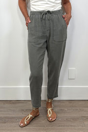 Front view of a woman wearing green straight leg pants