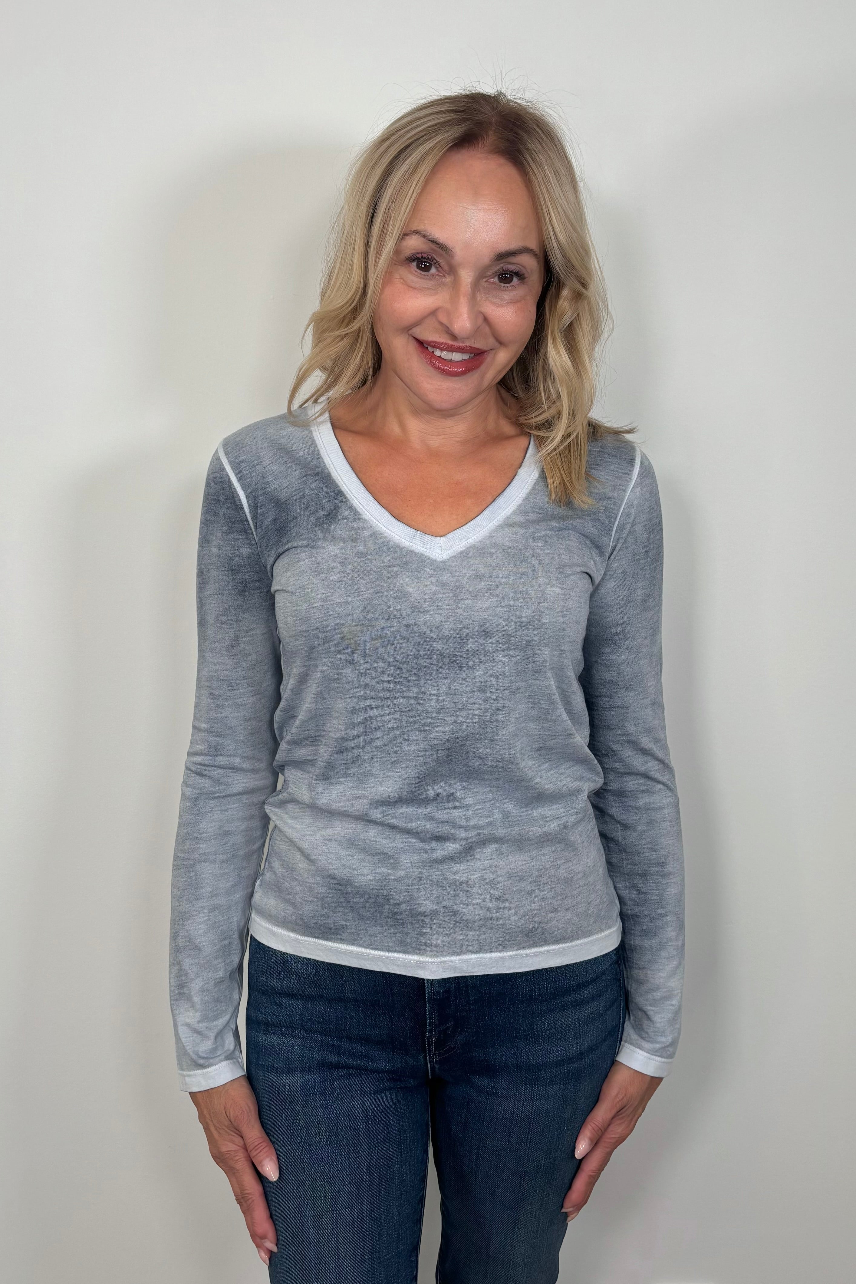 woman wearing a gray/blue v-neck long sleeve