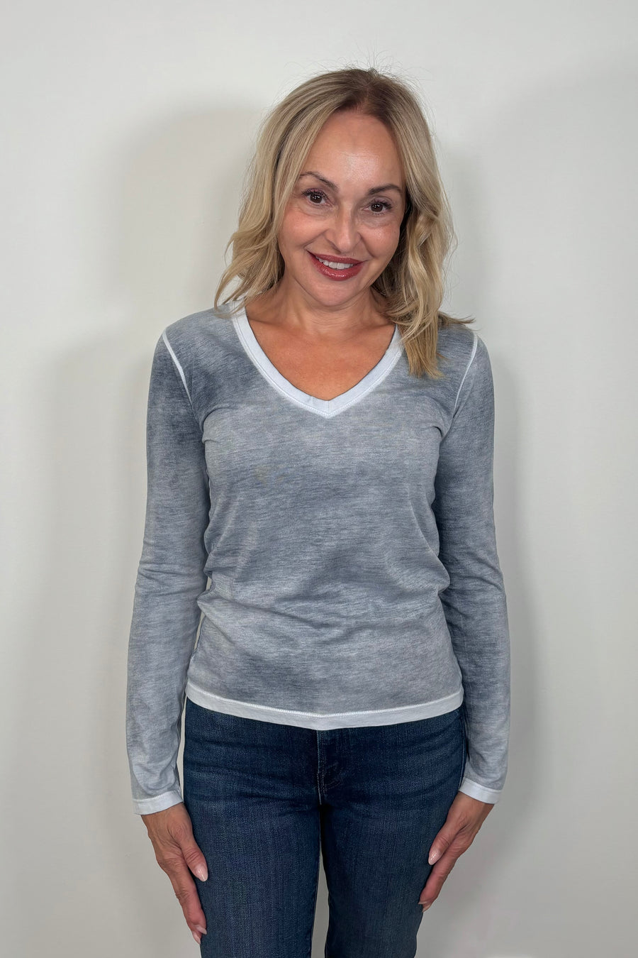 woman wearing a gray/blue v-neck long sleeve