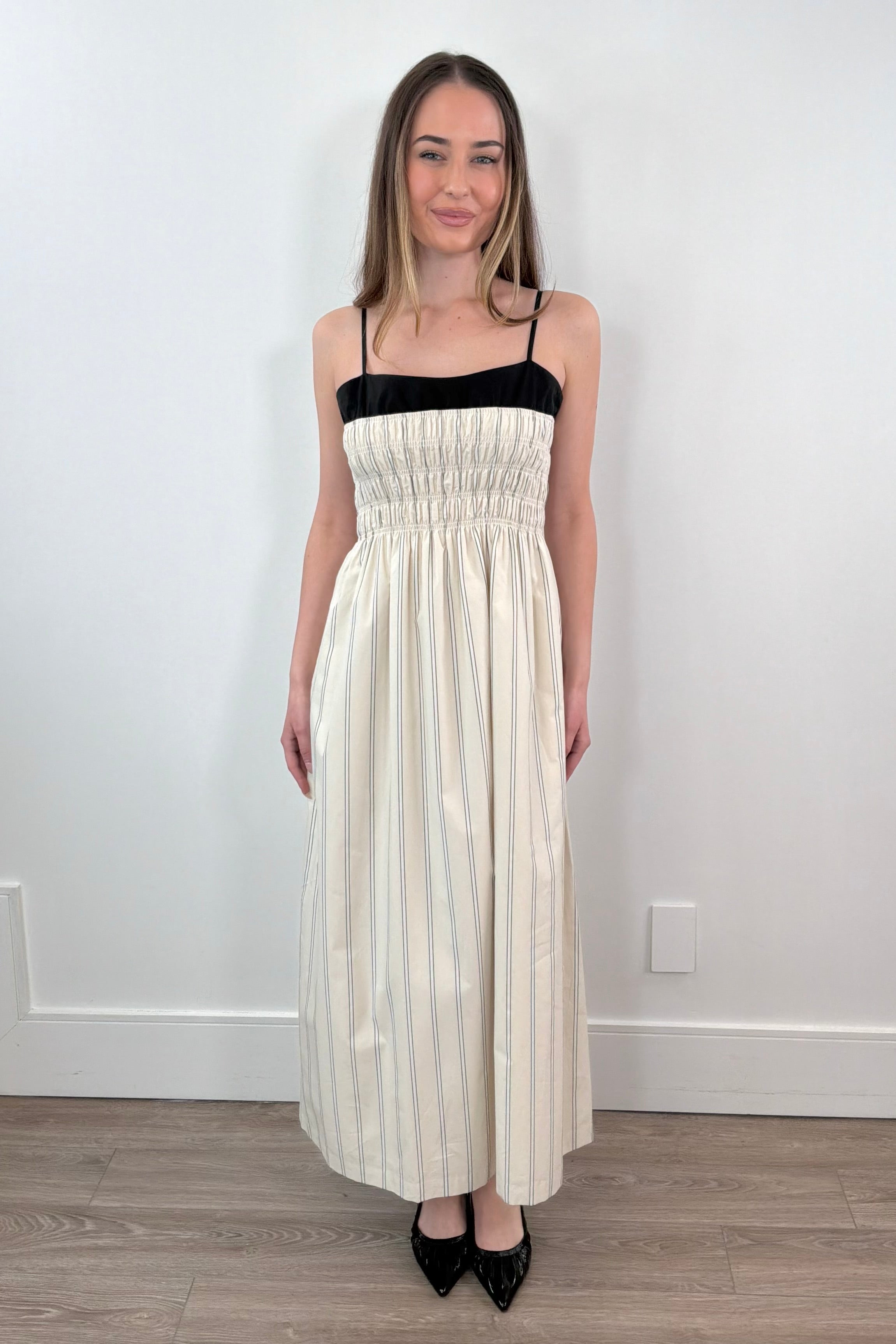 Woman wearing a layered striped dress in cream and black