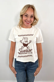 woman wearing a white tee with a brown maple syrup graphic