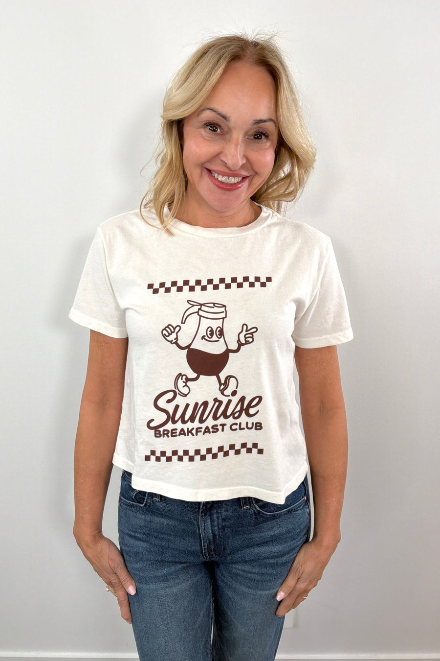 woman wearing a white tee with a brown maple syrup graphic