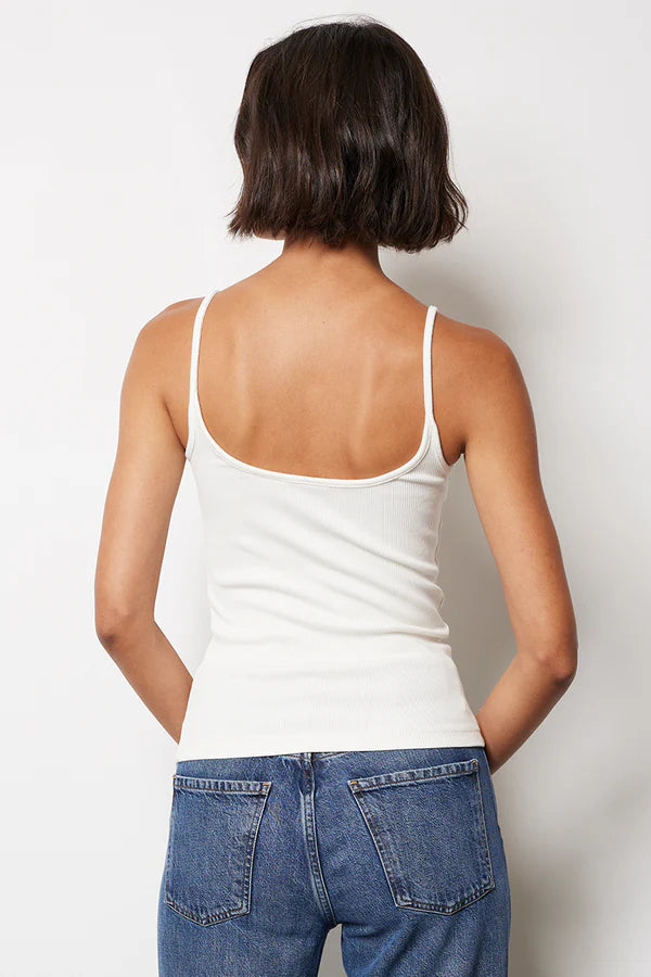 Woman wearing a white shirred tank top 