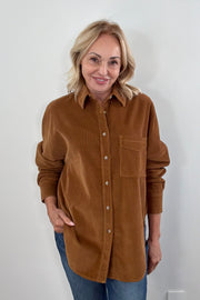 Woman wearing a brown cord button up long sleeve
