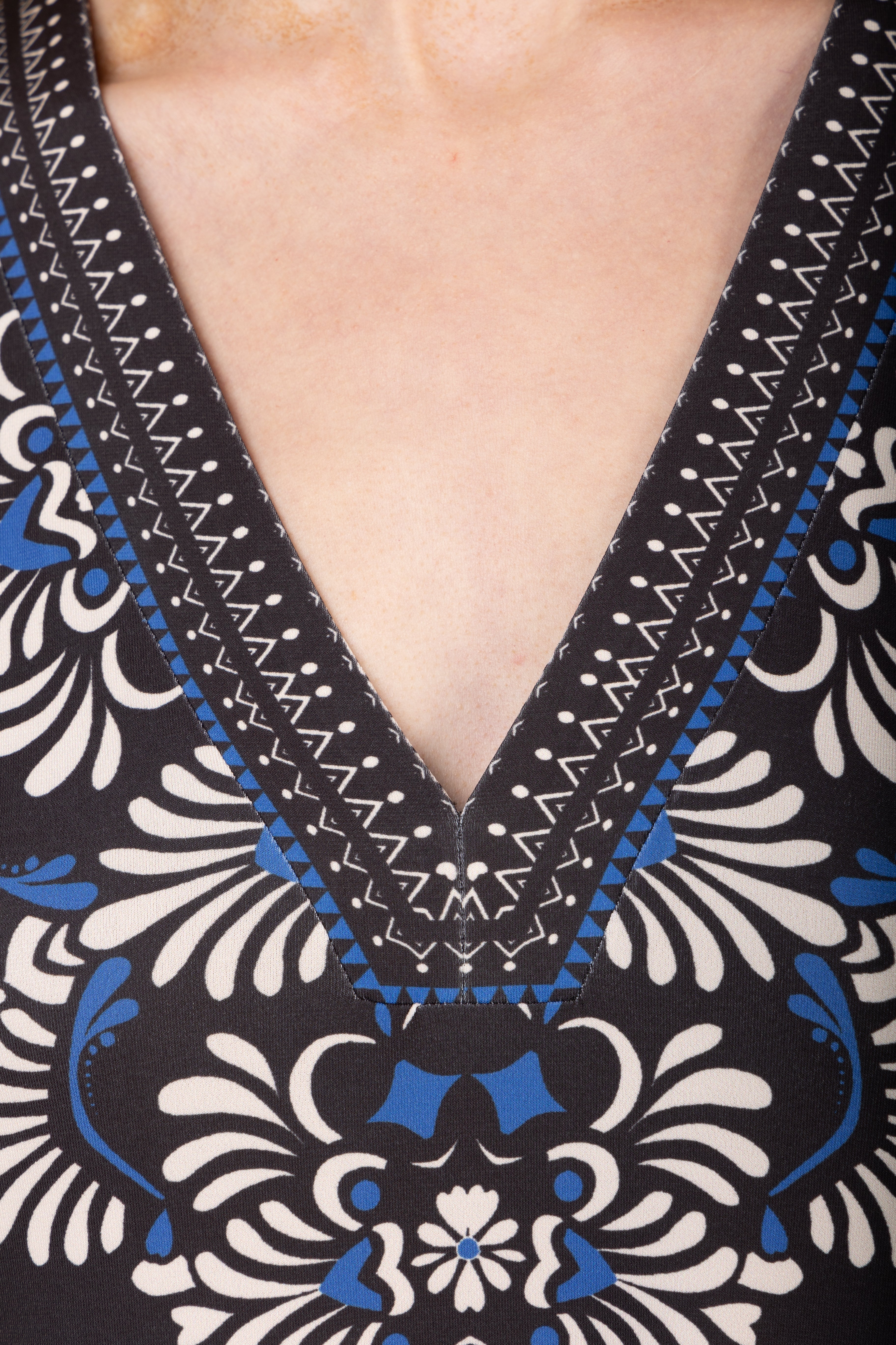 Close-up of a patterned garment with a deep V-neckline