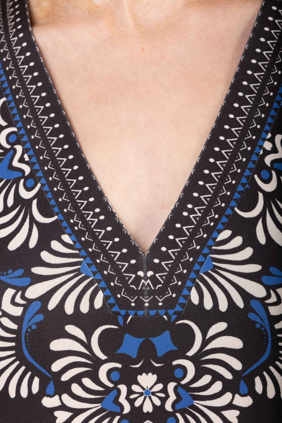 Close-up of a patterned garment with a deep V-neckline