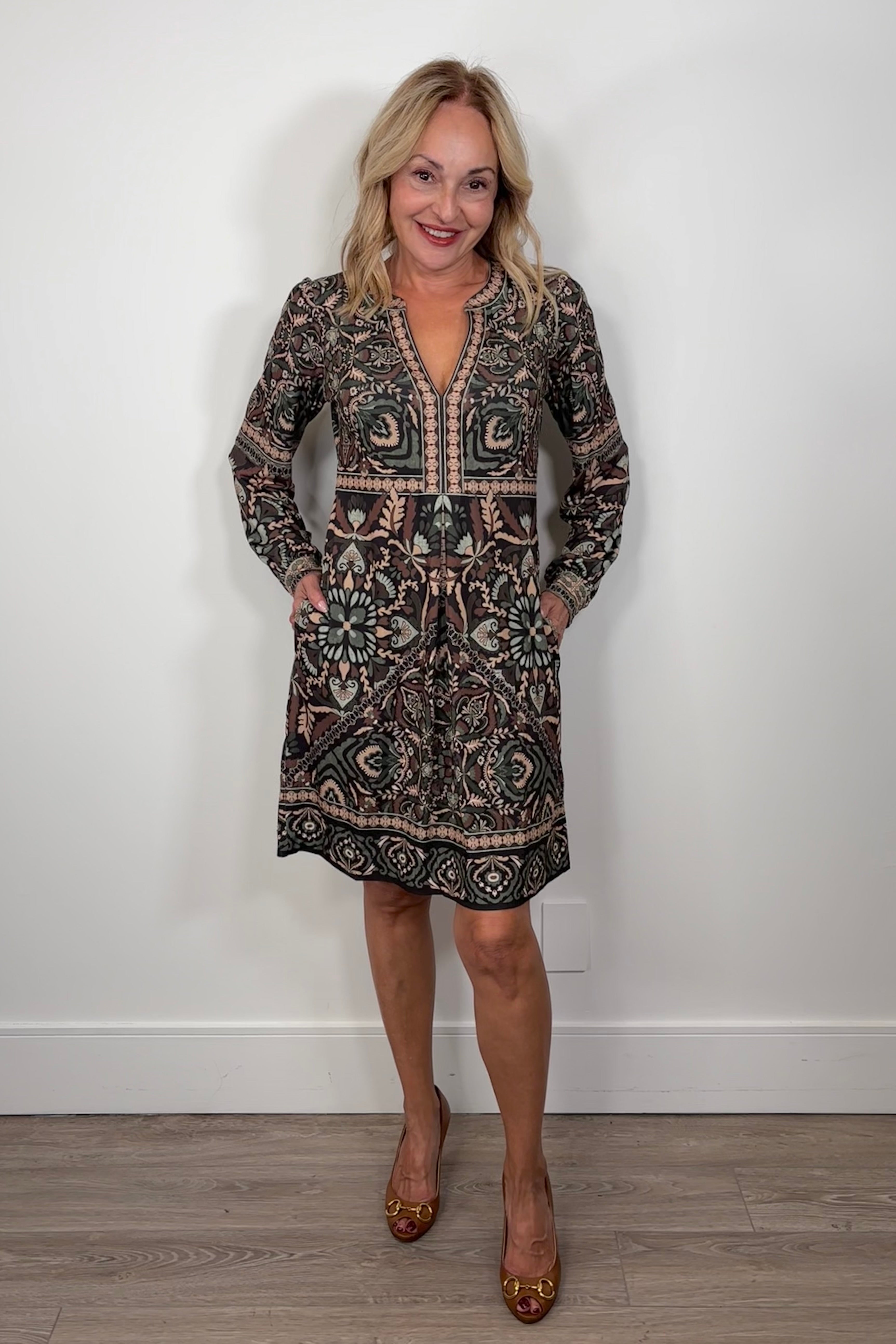 woman wearing short green long sleeve patterned dress