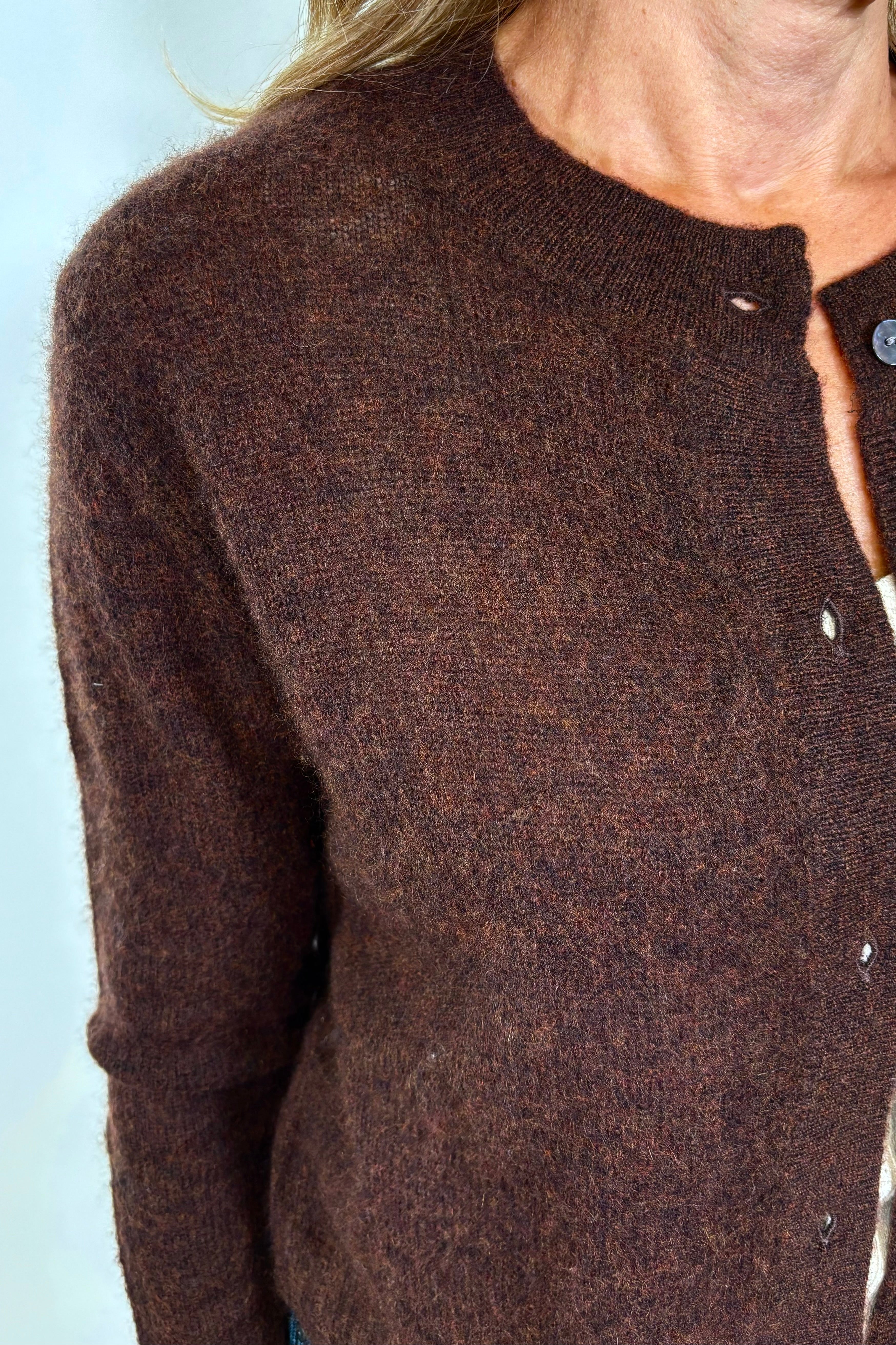 Zoom in picture of a woman wearing a brown cashmere and silk blend cardigan. 