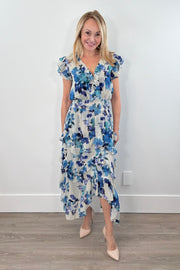Woman wearing a blue floral print ruffle dress