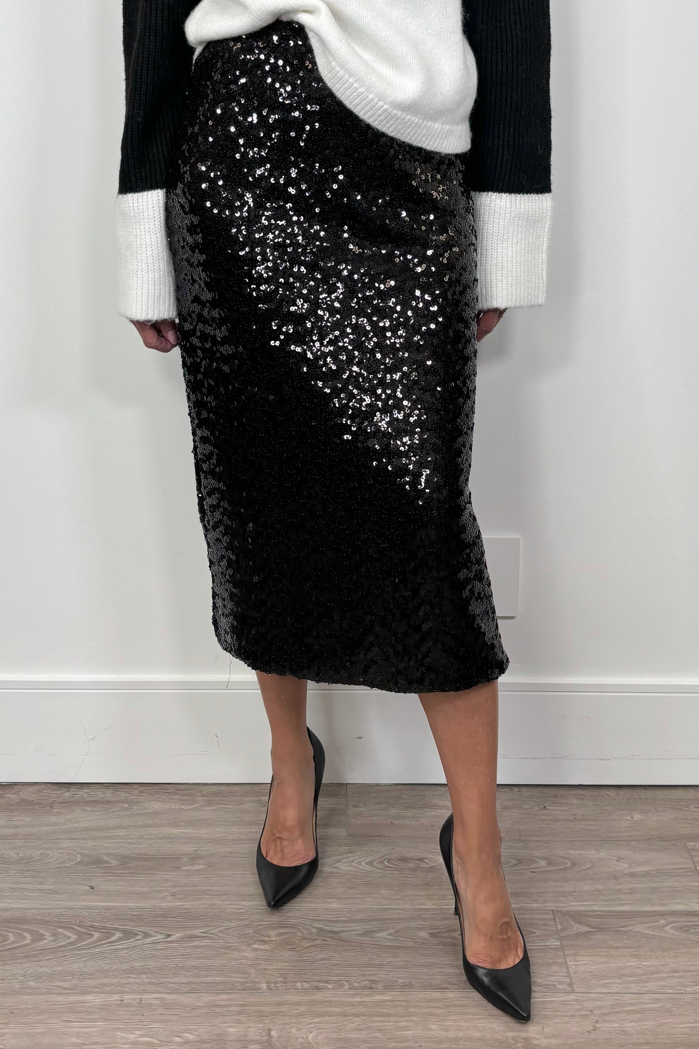woman wearing a black midi sequin skirt