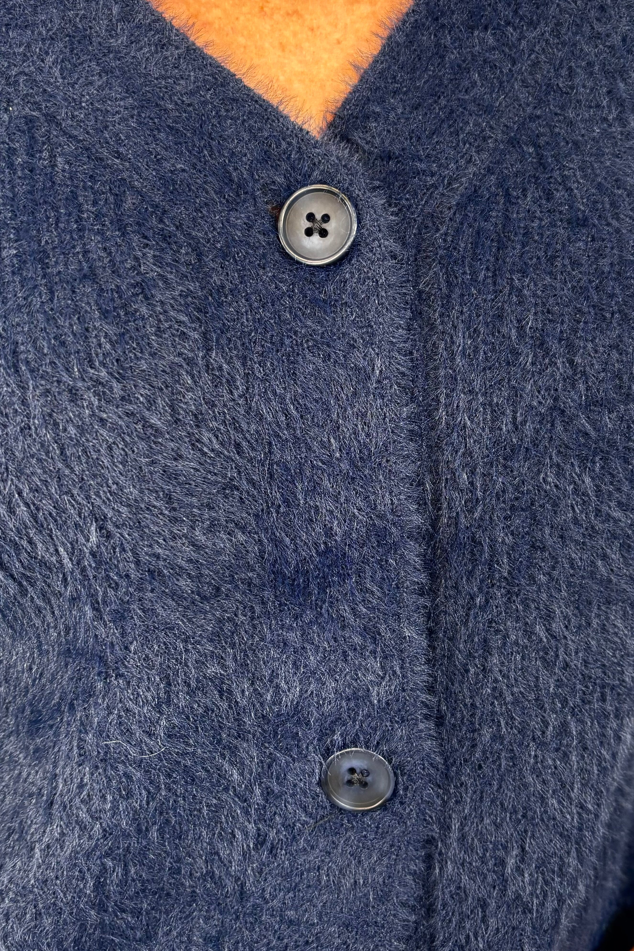 close-up of a blue cardigan
