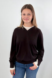 Woman wearing a brown and ivory sweater 