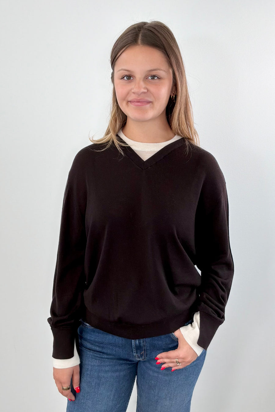 Woman wearing a brown and ivory sweater 