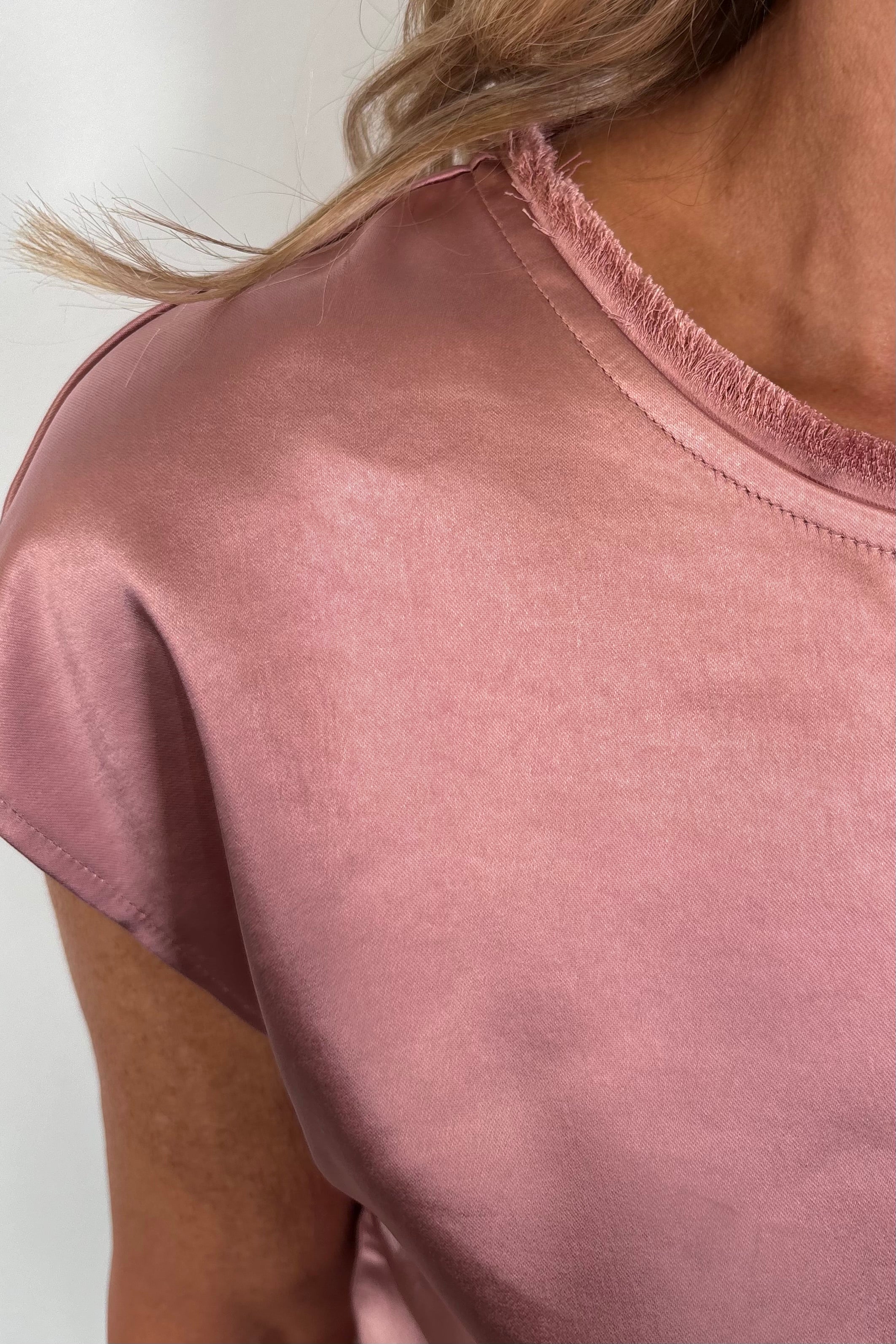 Close-up of a pink satin cap sleeve top