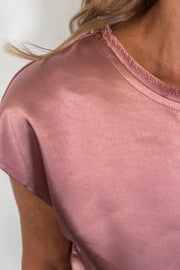 Close-up of a pink satin cap sleeve top