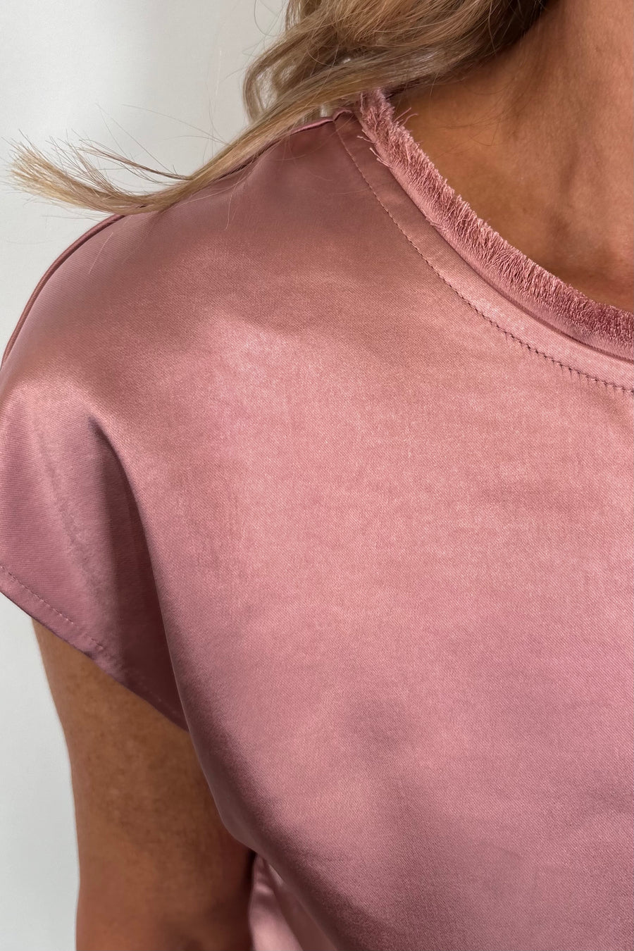 Close-up of a pink satin cap sleeve top
