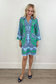 Woman wearing a blue and green patterned short dress with a 3/4 sleeves