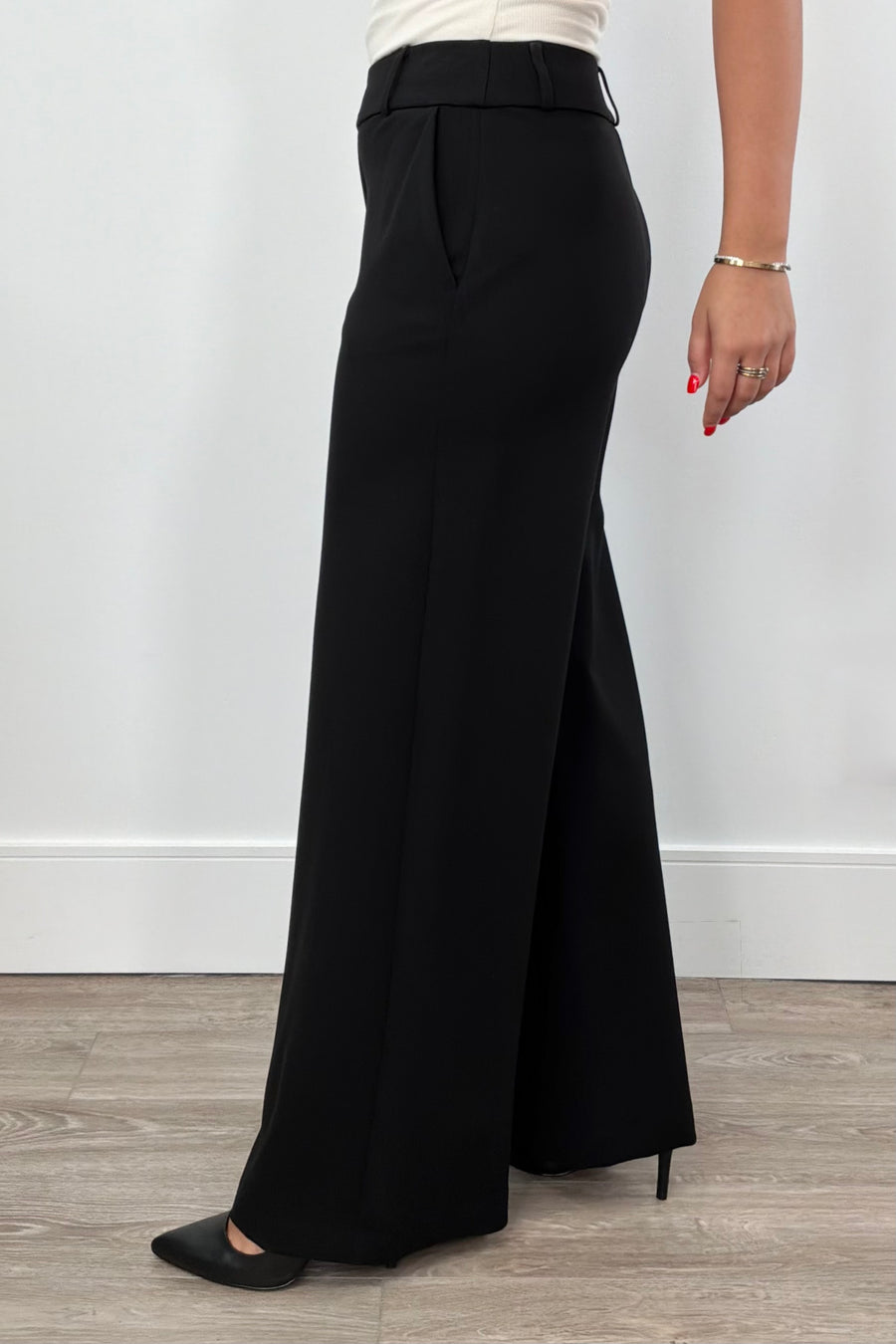 Women wearing black wide-leg pants