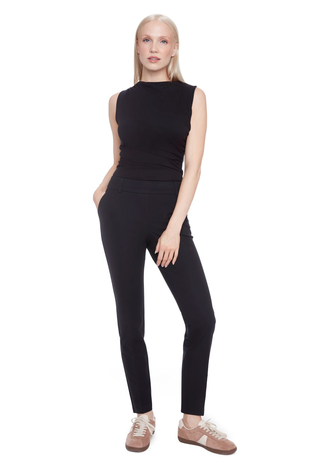 Front view of woman wearing a black sleeveless top and black compression pants 