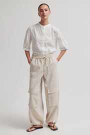 White button up blouse with cut out details
