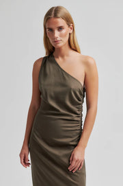 Woman wearing a one-shoulder olive green dress with ruched detail. 