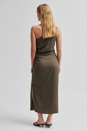 Woman wearing a one-shoulder olive green dress with ruched detail. 
