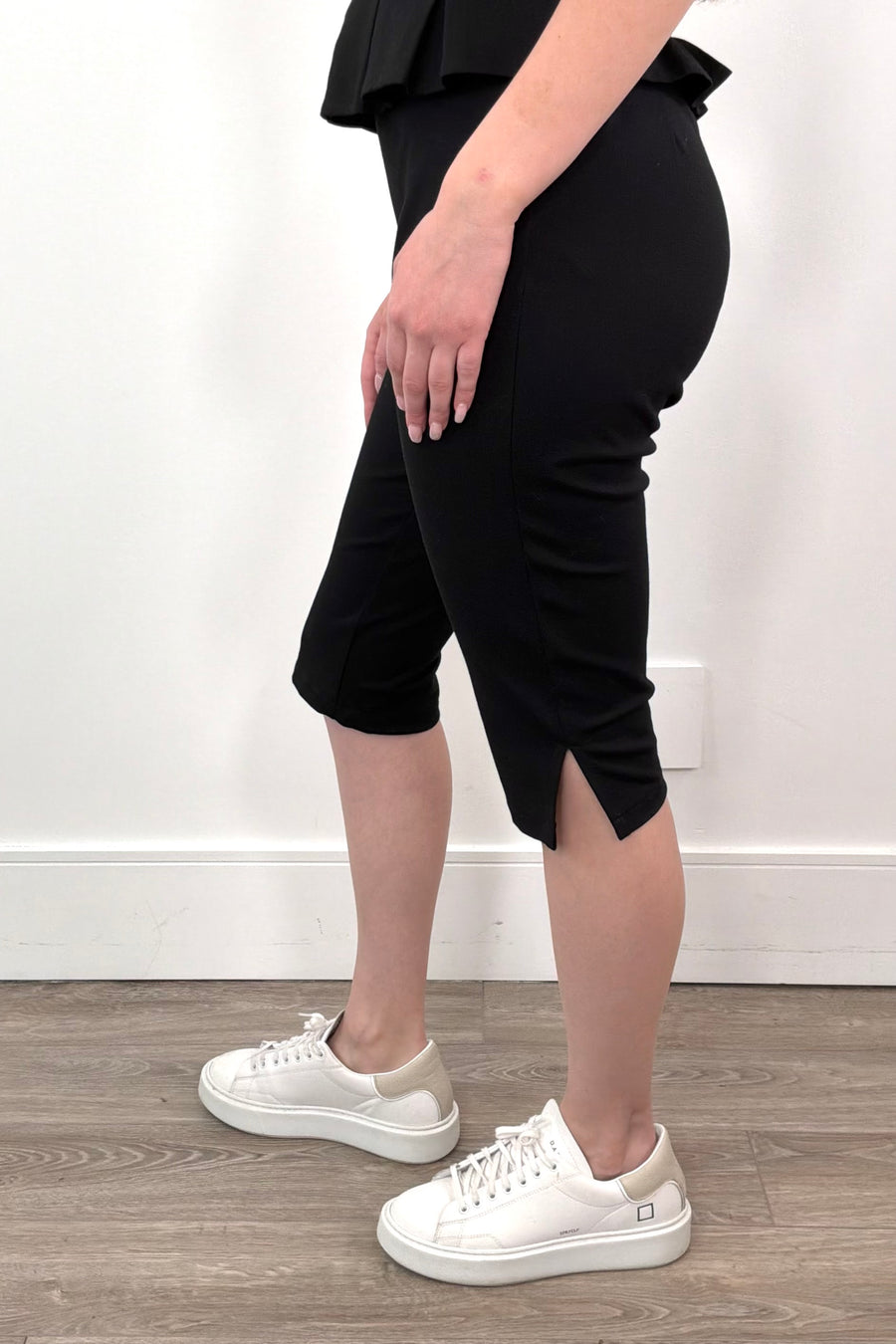 Side close up of Woman wearing black capri pants